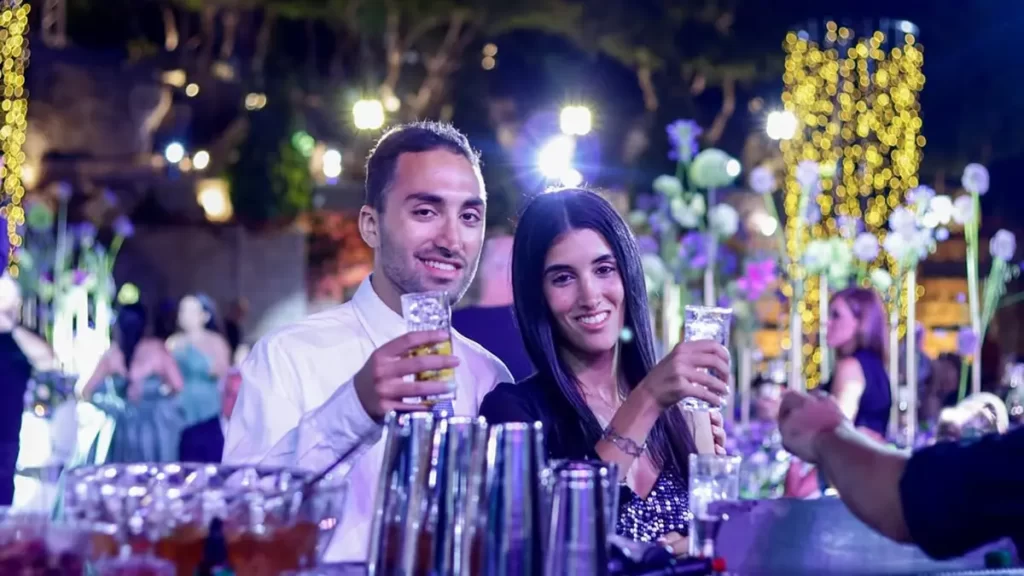 Couple enjoying cocktails at Goa beachside wedding bar