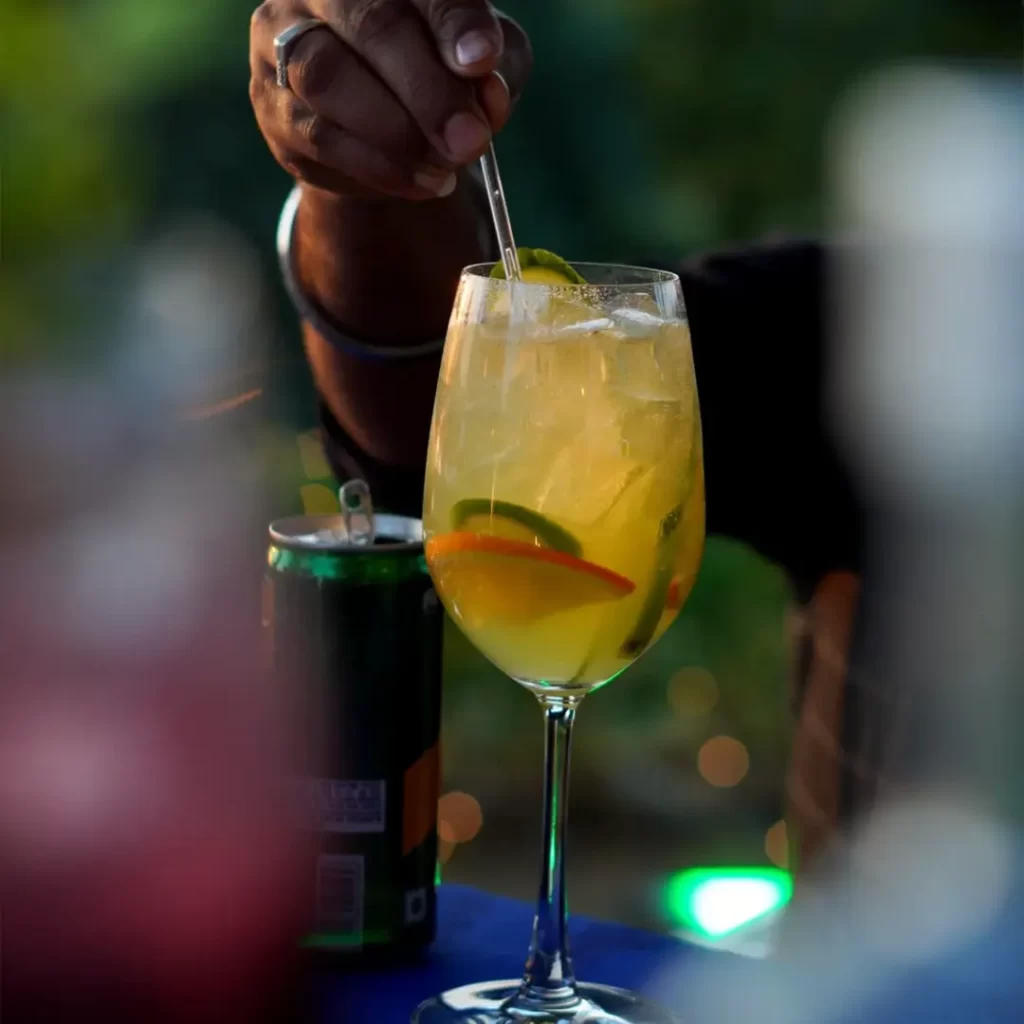 Mixologist adding fresh herbs to craft cocktail.