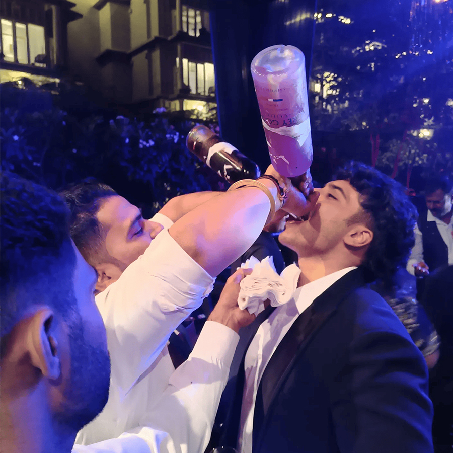 Flair bartender entertaining guests at wedding bar in Goa